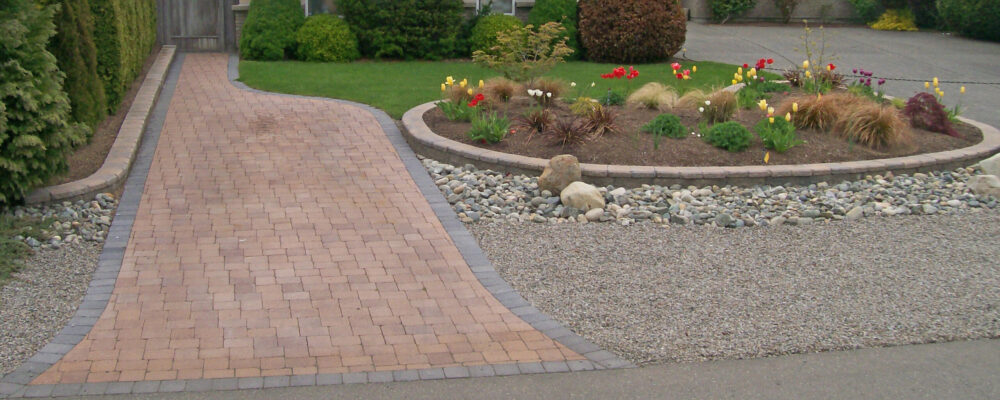 paver driveway with garden enclosure